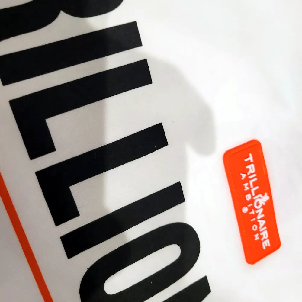 Photo of the back print beside the orange label