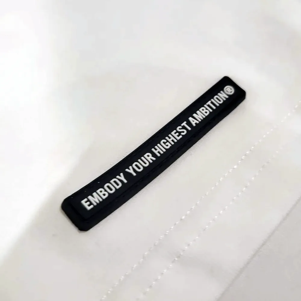 Photo of the small black rubber patch at the hem
