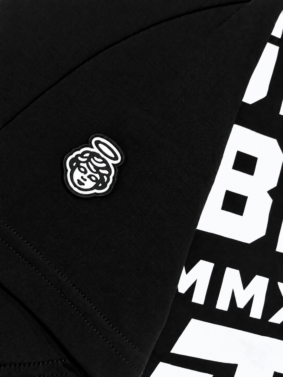 Close-up of the black and white haloed angel rubber patch on the sleeve
